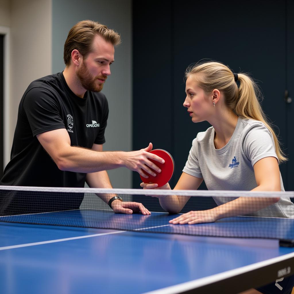 Experienced table tennis coach providing personalized instruction to a member at Austin Table Tennis Club