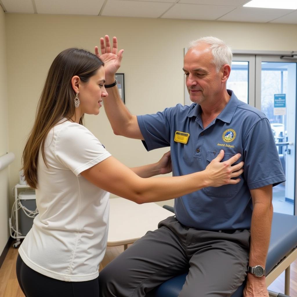 A burn survivor receiving physical therapy in a well-equipped rehabilitation center.