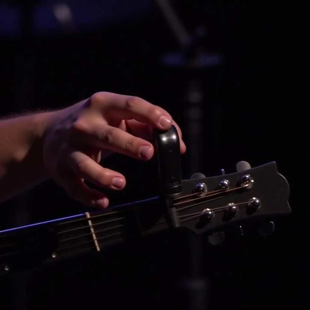 Musician Discreetly Using Mini Tuner on Stage