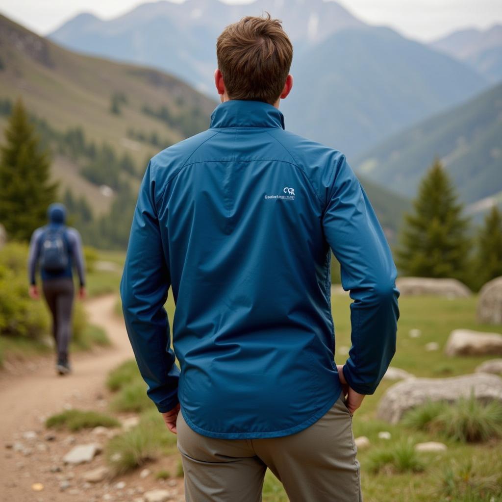 A hiker wearing the Outdoor Research Helium Down Jacket while hiking