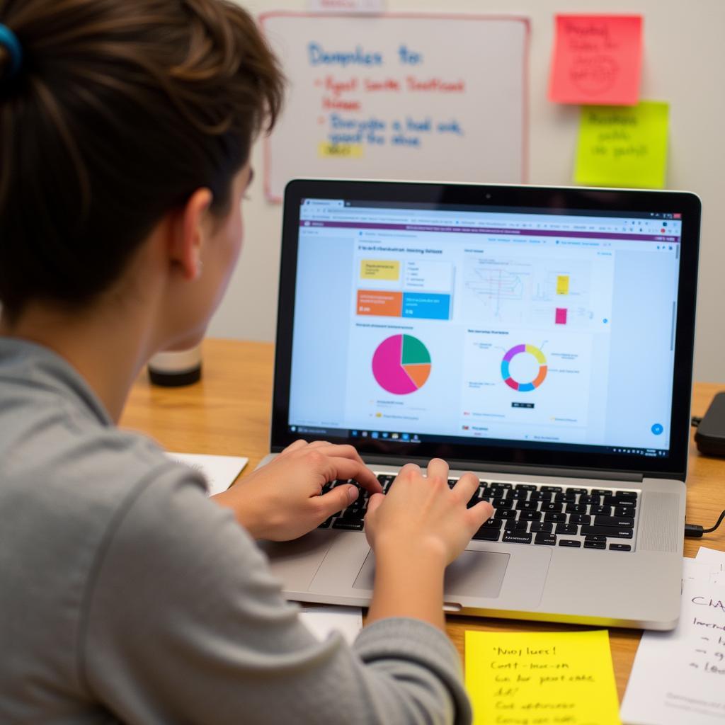 A junior UX researcher diligently working on their laptop, analyzing user data and preparing for user interviews.